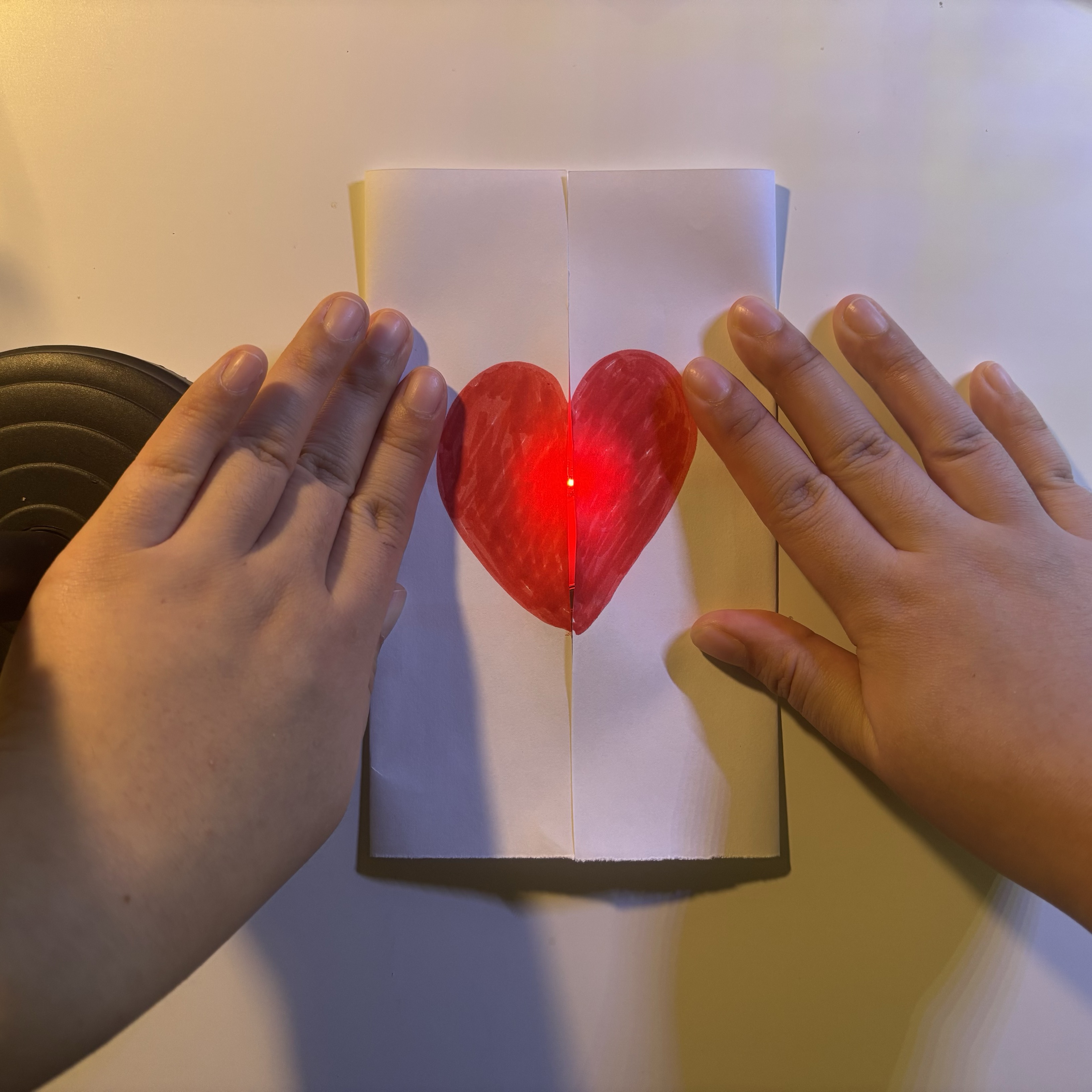 On top of the two disconnects, I made a heart card that requires both hands to interact. The user needs to fold the paper and press it in order to make the LED light up.