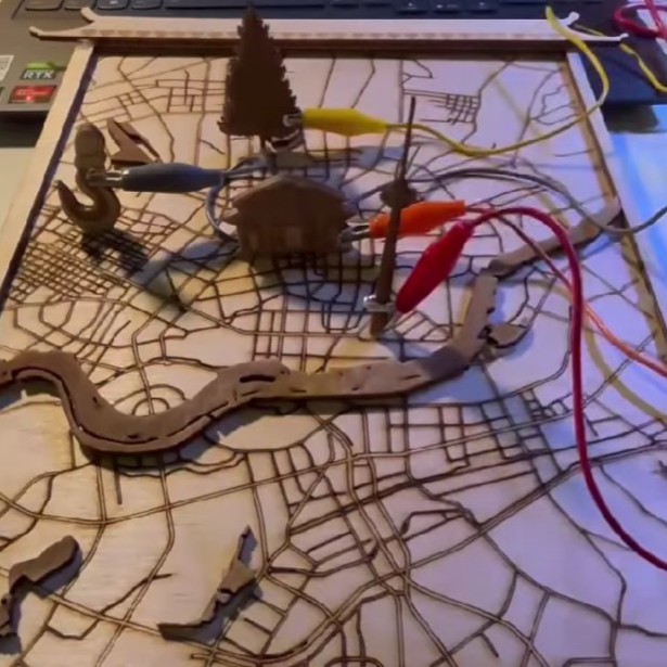 Therefore, I decided to keep the idea of vertically attaching the landmarks to the map. By applying metal conductors to the wooden blocks, viewers can touch the conductors to trigger sounds and visual effects representing the different landmarks.