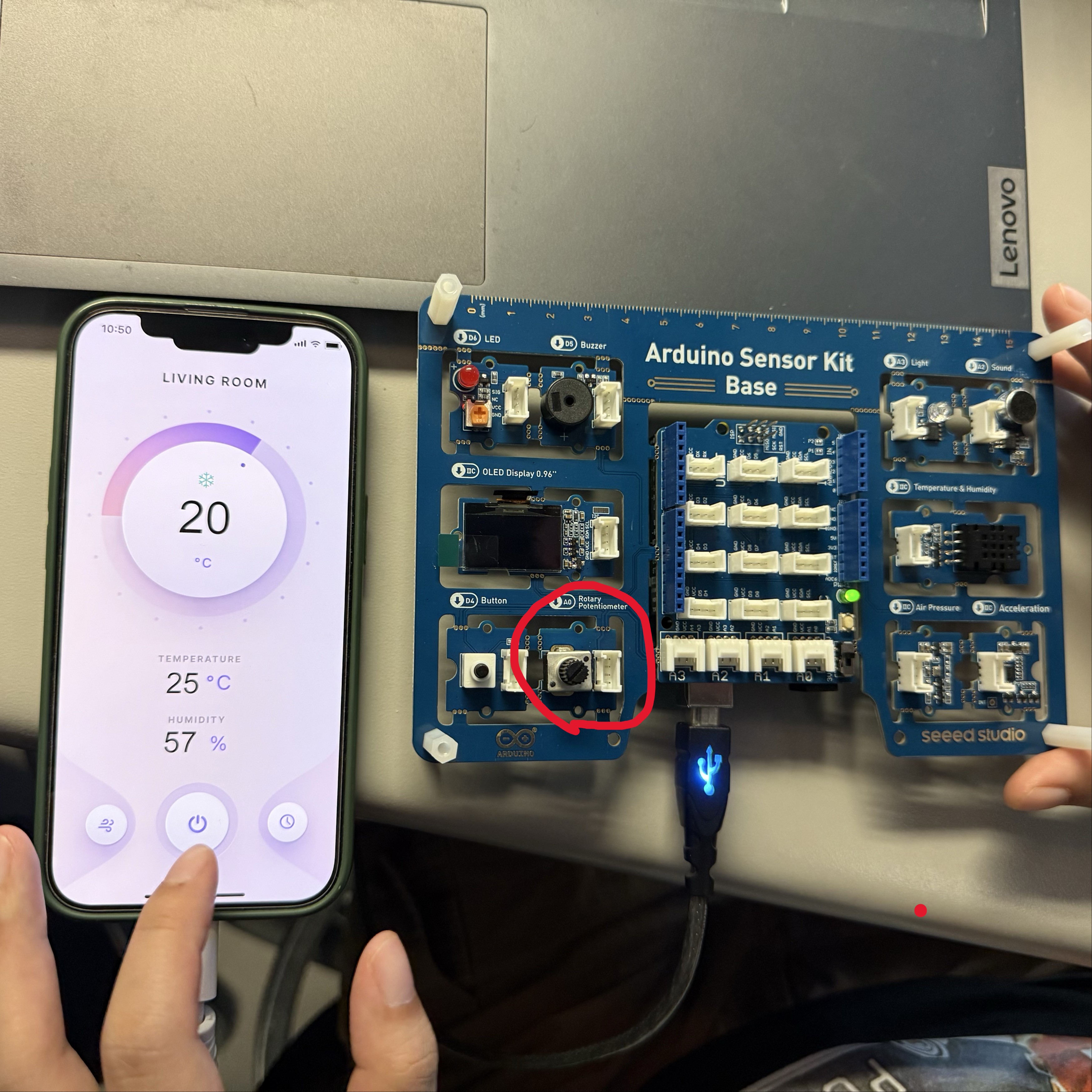 After spending some time downloading and running ProtoPie on our phones, we displayed the interface shown in the picture. The code we just uploaded allows us to control the living room temperature by rotating the rotary potentiometer on the circular section.
