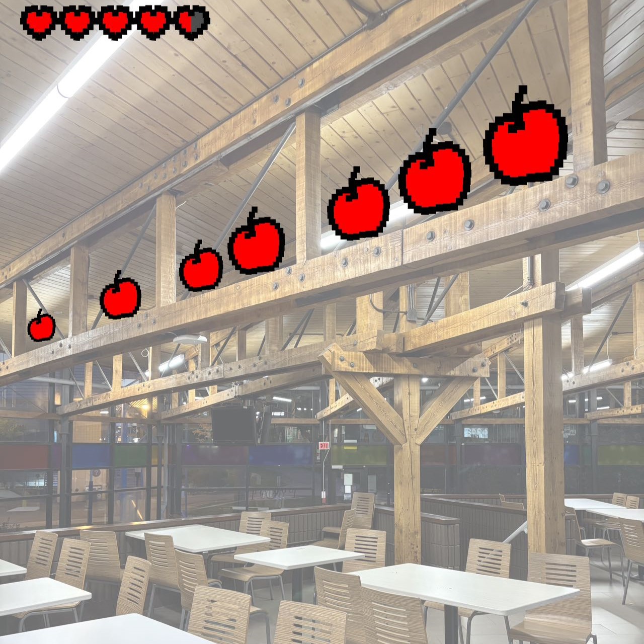 In addition to placing real decorations, we also stretched our ideas and designed the cafeteria as a virtual place. We added some pixelated symbols to simulate a gaming scene. We placed pixelated apples on the beams of the room, which the player eats to replenish the life value in the upper left corner. In a sense it also echoes the function of the cafeteria for people to have meals.
