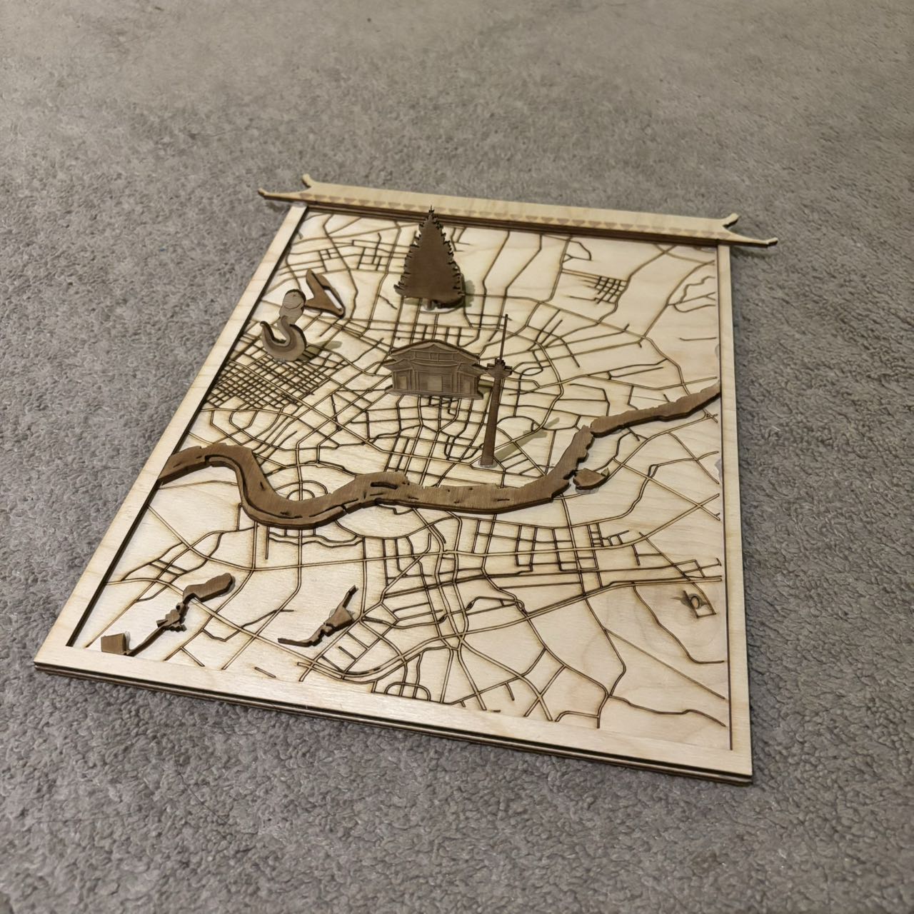 I chose the laser cut map as my final design. I show part of the map of my hometown, Shenyang. And I chose four of the most well-known attractions that I personally think best represent the city of Shenyang, cut and glued them on the map.
In order to increase the interactivity and fun, I used Makey Makey and Scratch, when the user touches different landmarks, it will trigger the sound effects related to the landmarks, which are the sound of steel in the factory, the sound of stepping on snow, the sound of Erhu, and the sound of the crowd in the night market. This can give the user a more immersive experience, help them understand my city, and express how much I miss my hometown.
